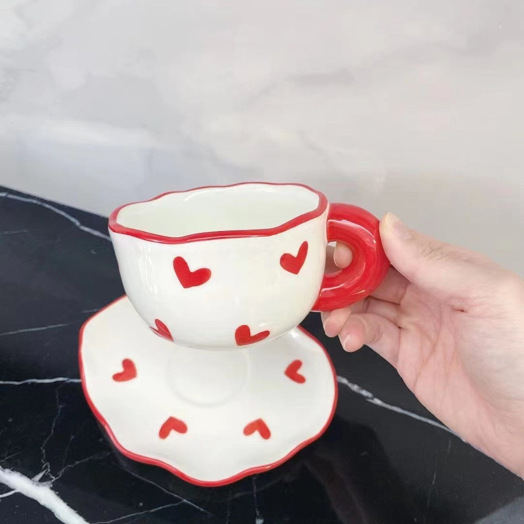 Colorful teatime cup and saucer - red hearts