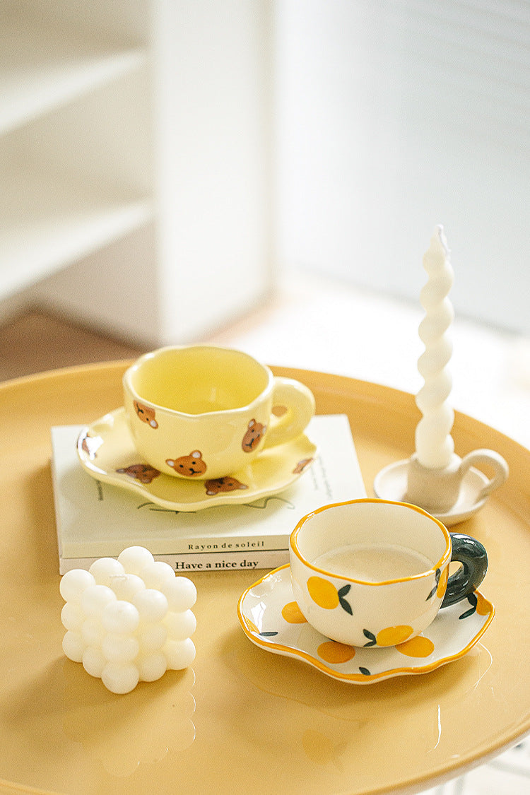 Colorful teatime cup and saucer - yellow bear and lemon side view