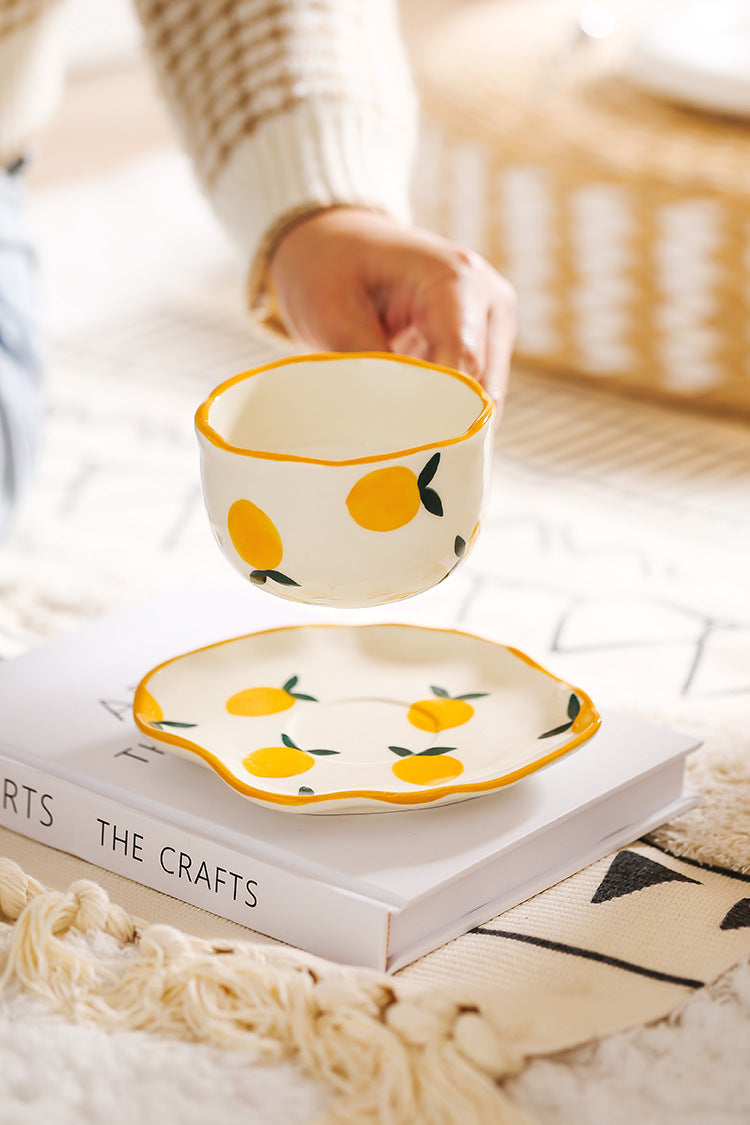 Colorful teatime cup and saucer - holding the lemon cup