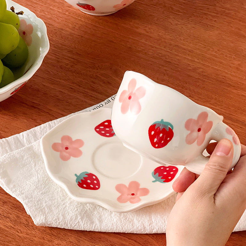 Colorful teatime cup and saucer - side view of flower strawberry